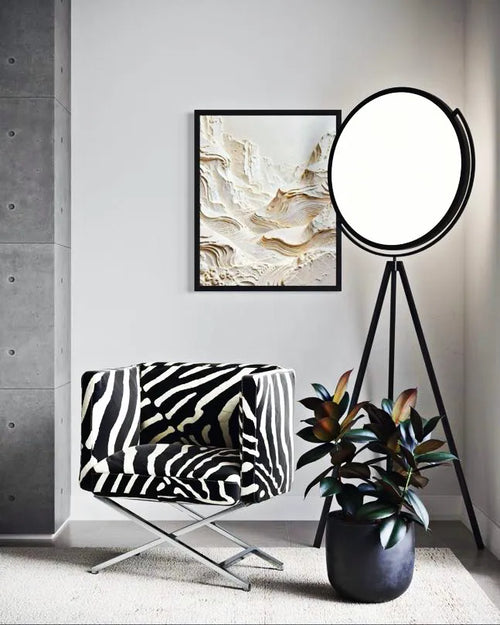 Modern interior with a zebra-patterned chair, round floor lamp, and abstract art on the wall.