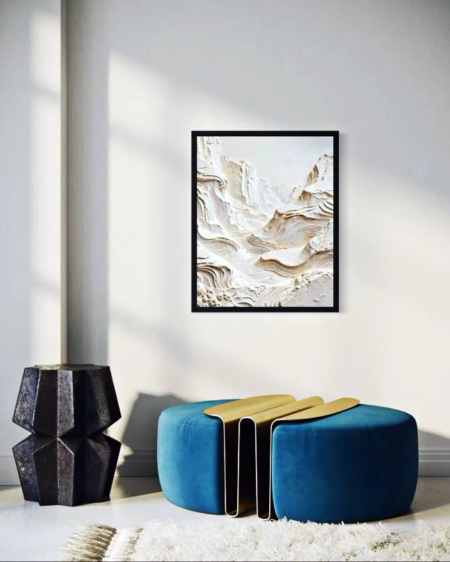 Modern interior with abstract art, blue ottoman, and black vase.