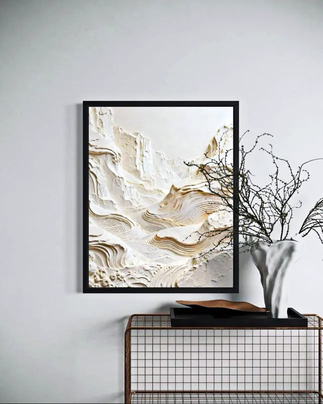 Abstract art print in a black frame on a wall above a console table.